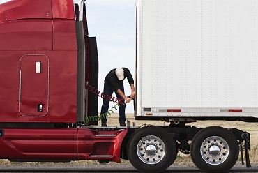 Driver checking rig before calling mobile truck service