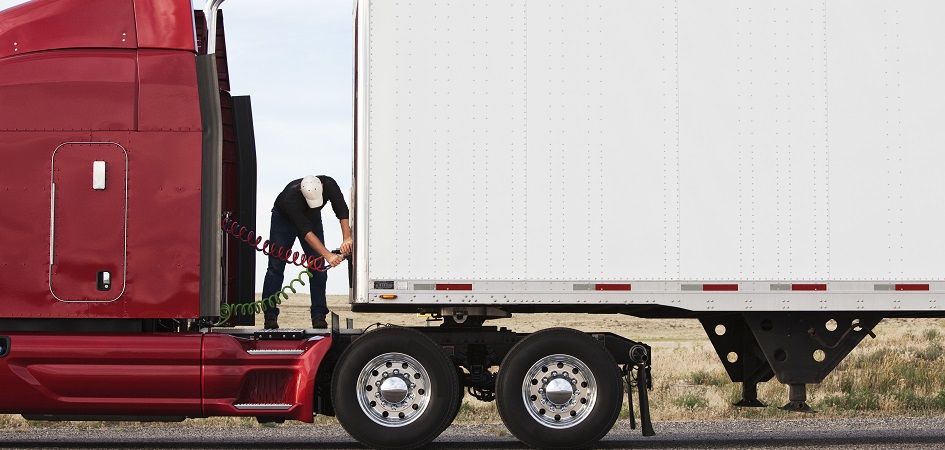 Driver checking rig before calling mobile truck service